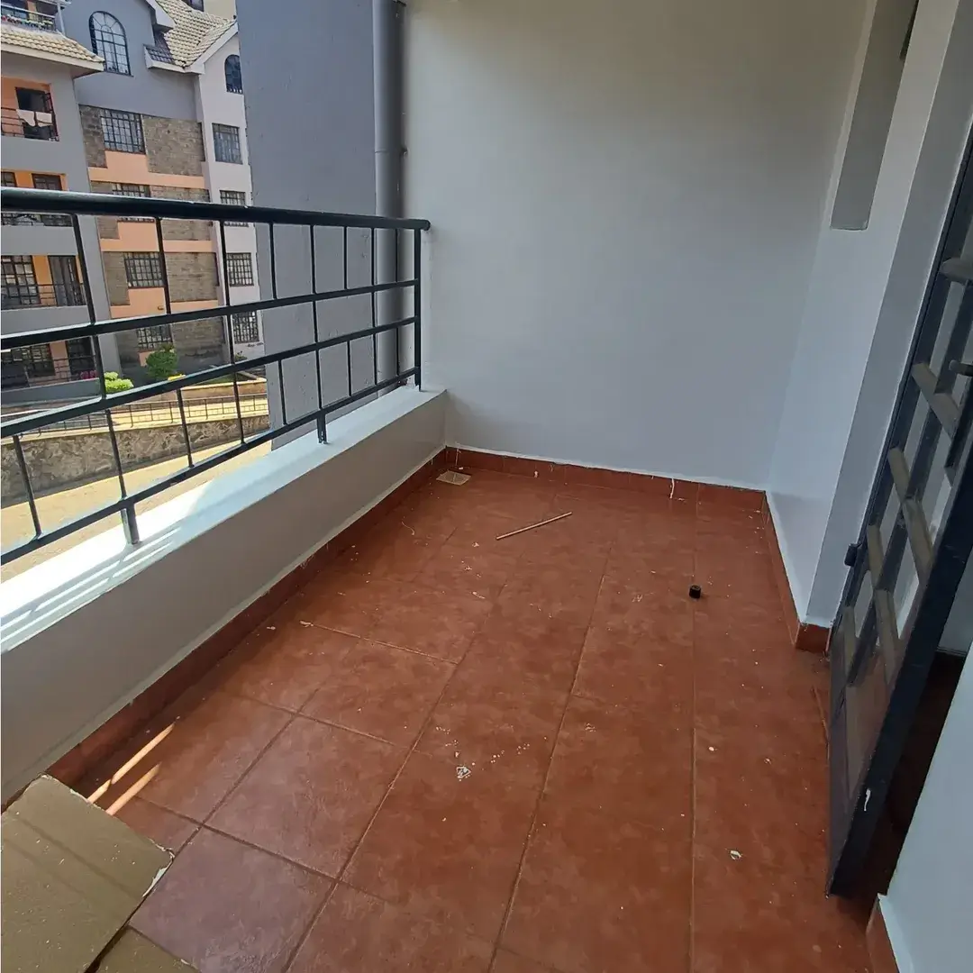 Spacious balcony with metal railing and city views