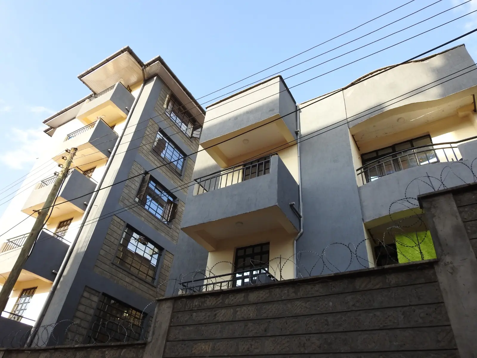 Multi-story residential building facade with balconies and windows
