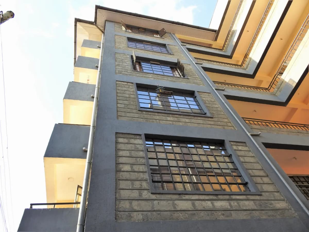 Modern multi-story residential building facade with horizontal lines
