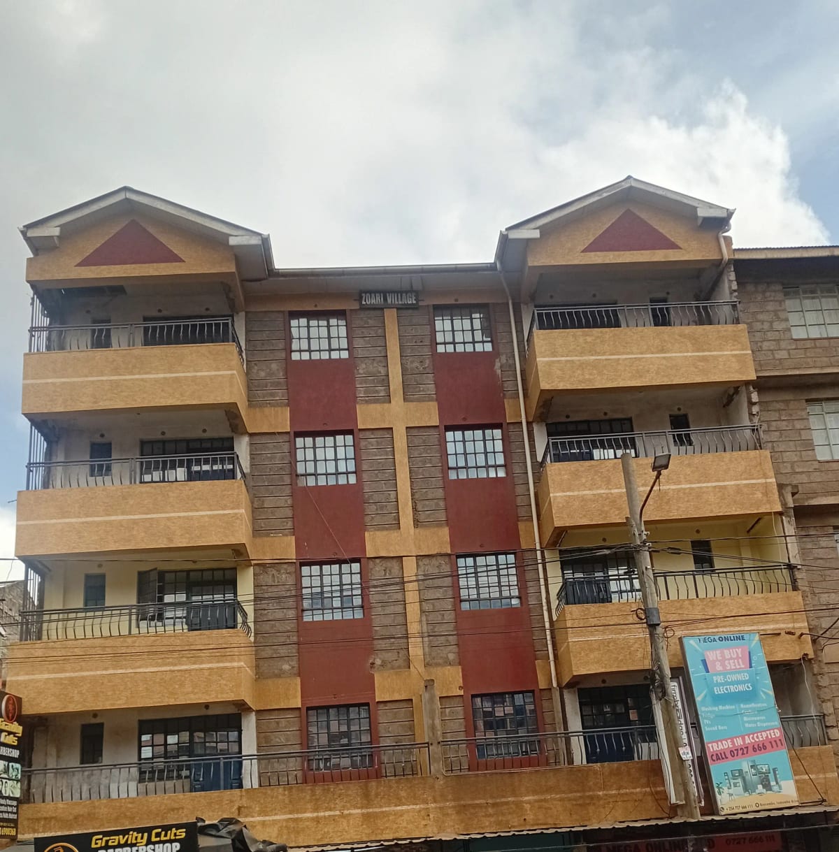 Multi-story residential building with yellow and red facade
