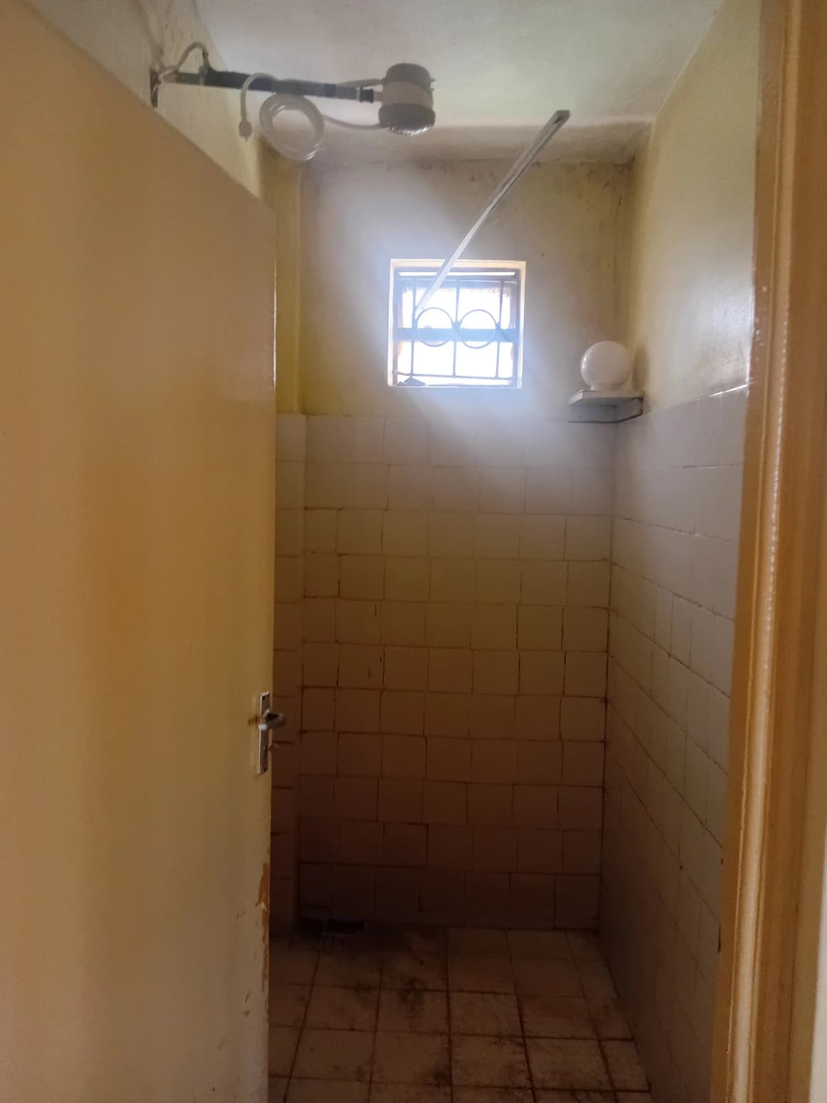 Simple bathroom with shower enclosure and small window