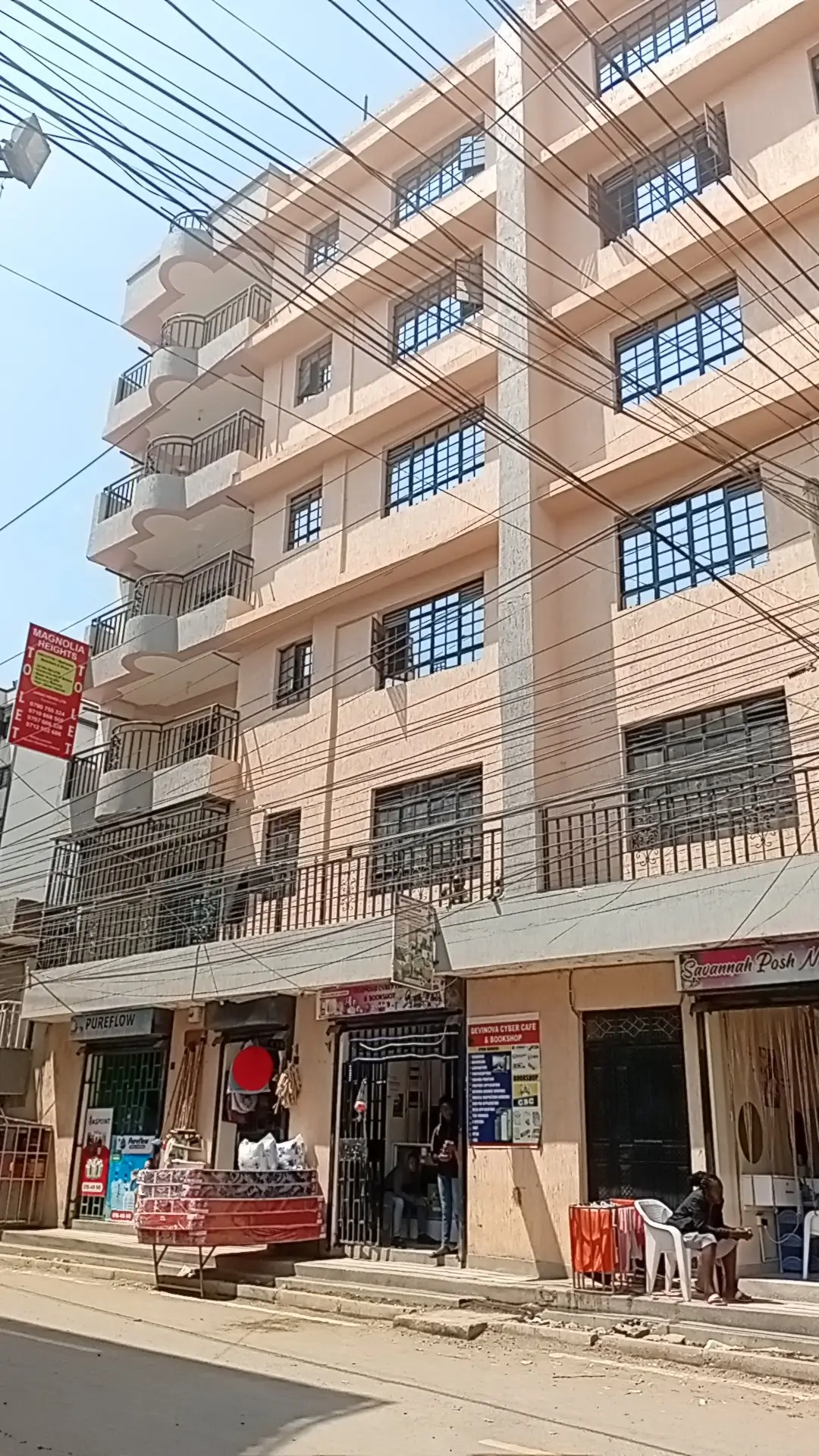 Multi-story residential building facade with street-level shops