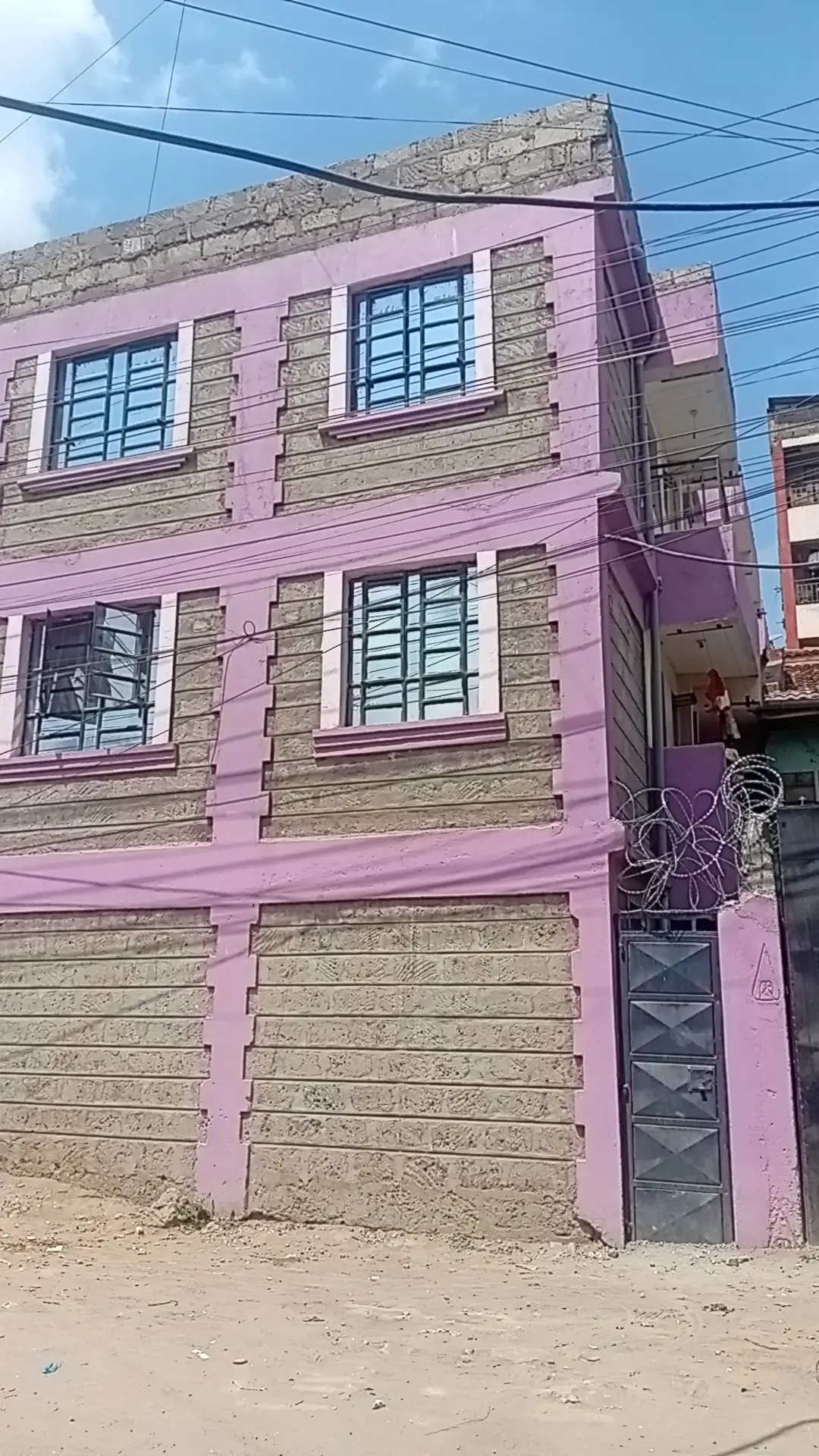 Pink and stone facade multi-story residential building front
