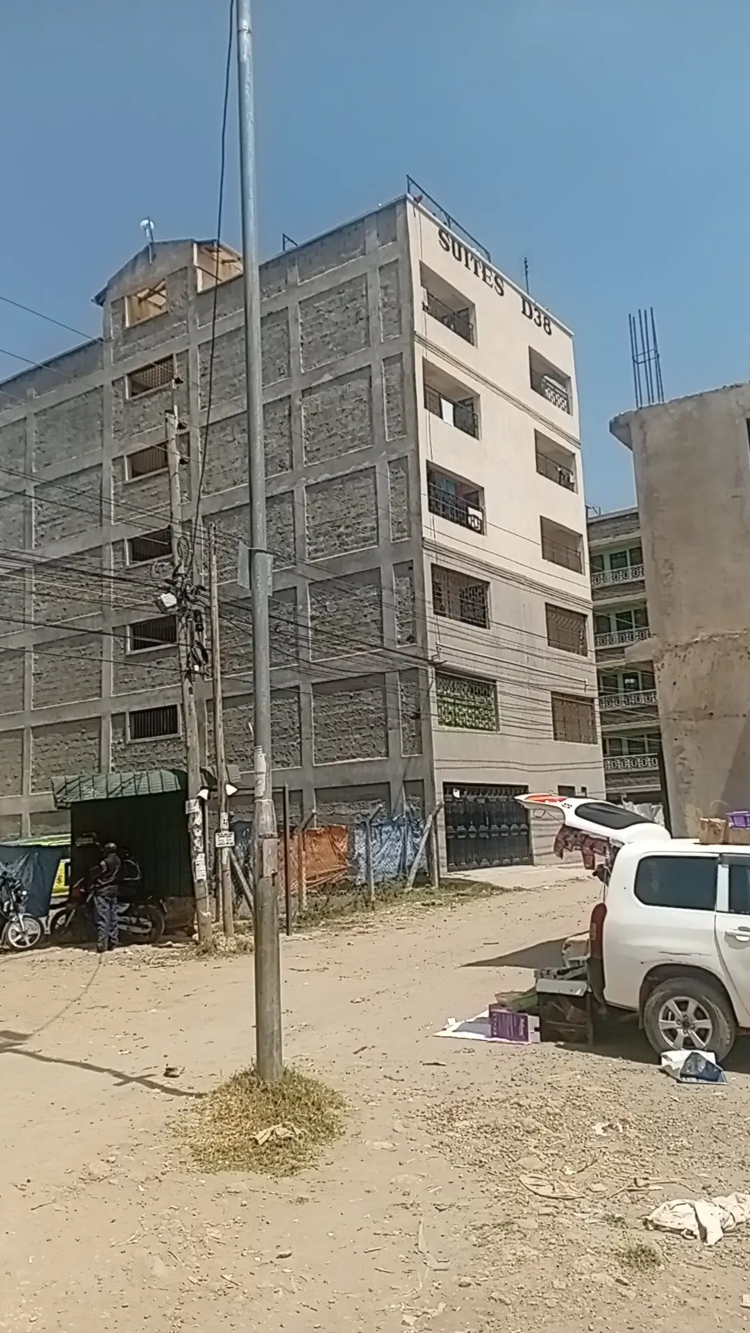 Multi-story residential building facade with compound entrance