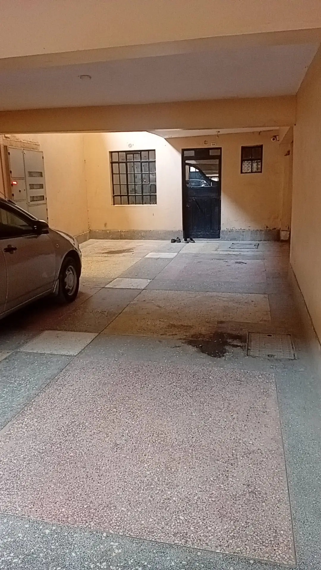 Covered parking bay with vehicle parked inside
