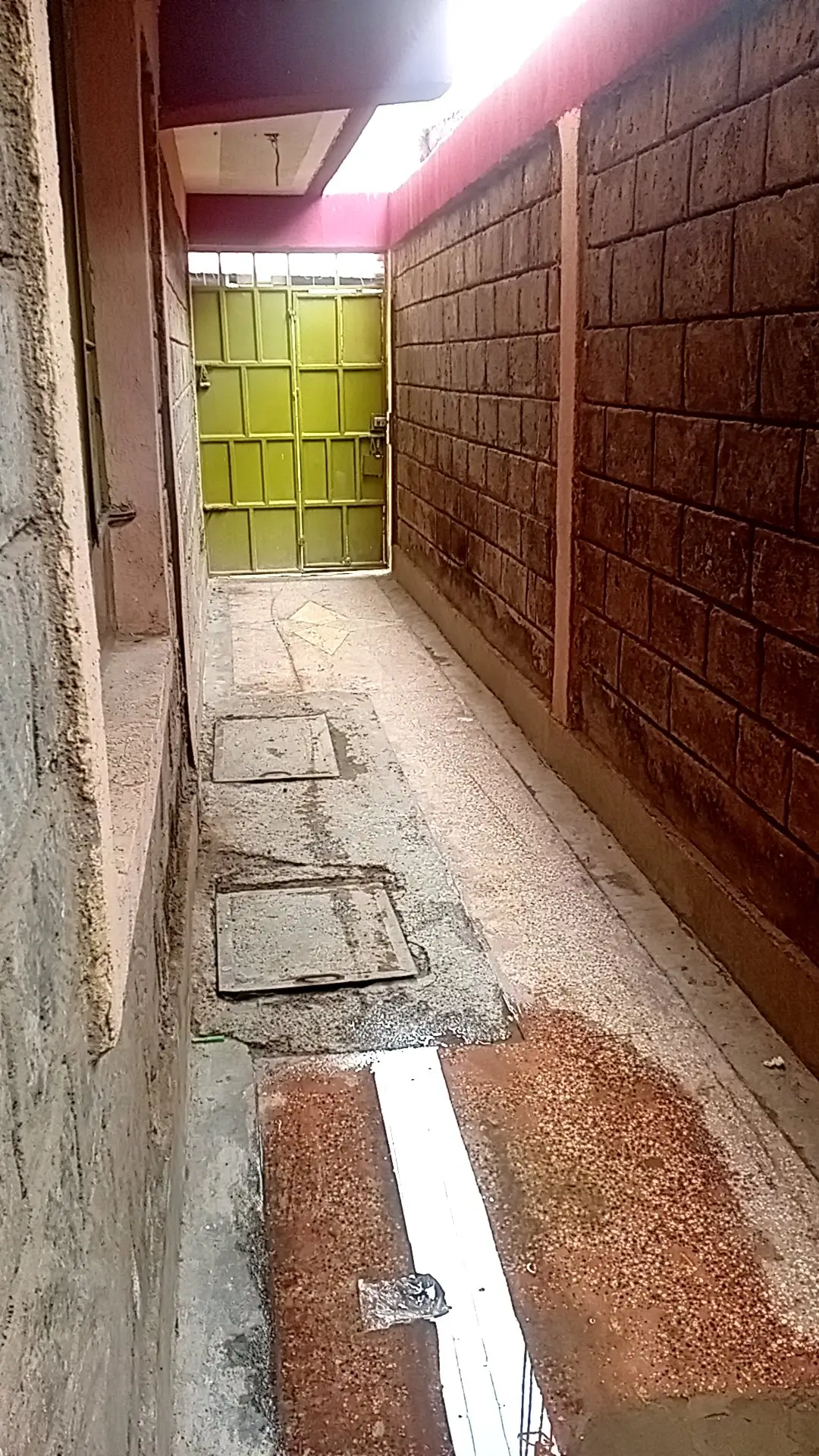 Narrow parking bay with yellow gate entrance