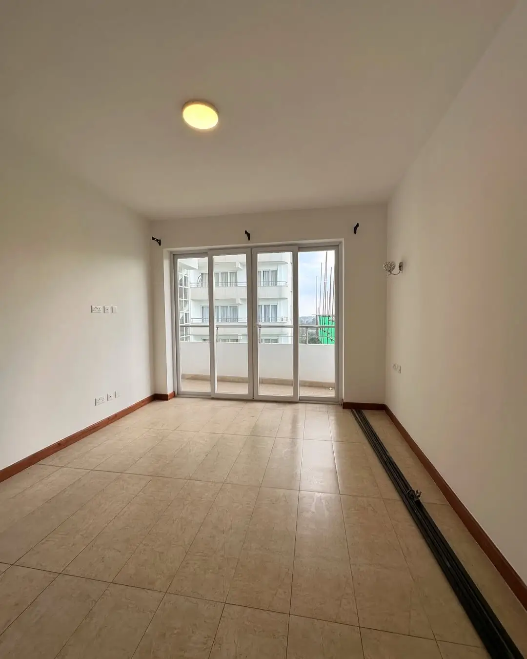 Bright balcony with glass sliding doors and tiled flooring