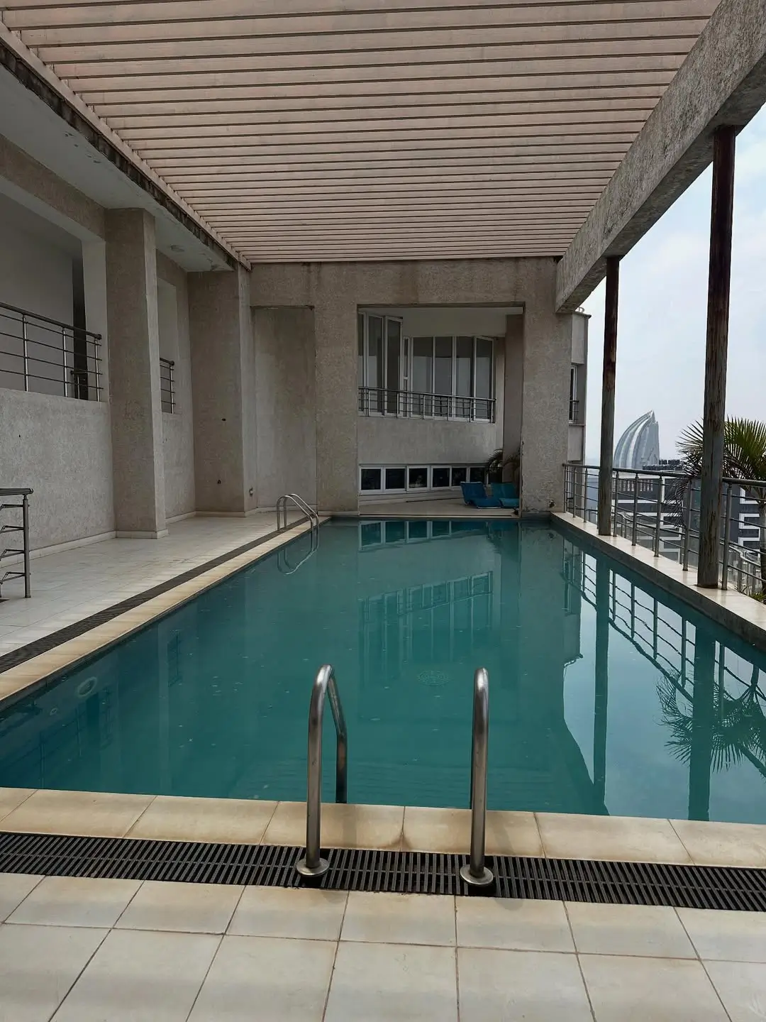 Indoor swimming pool with turquoise water and metal railings