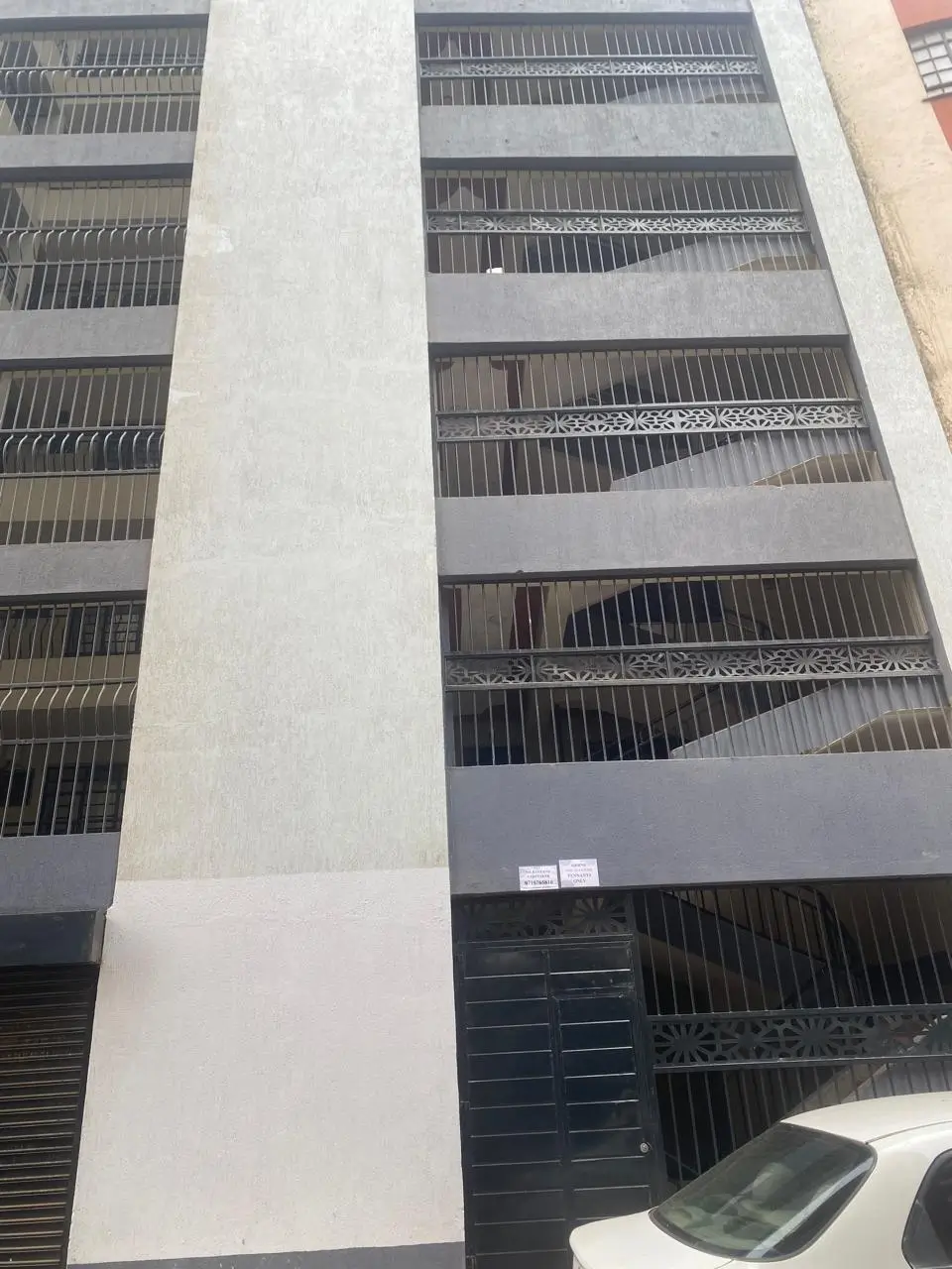Multi-story residential building facade with metal balconies